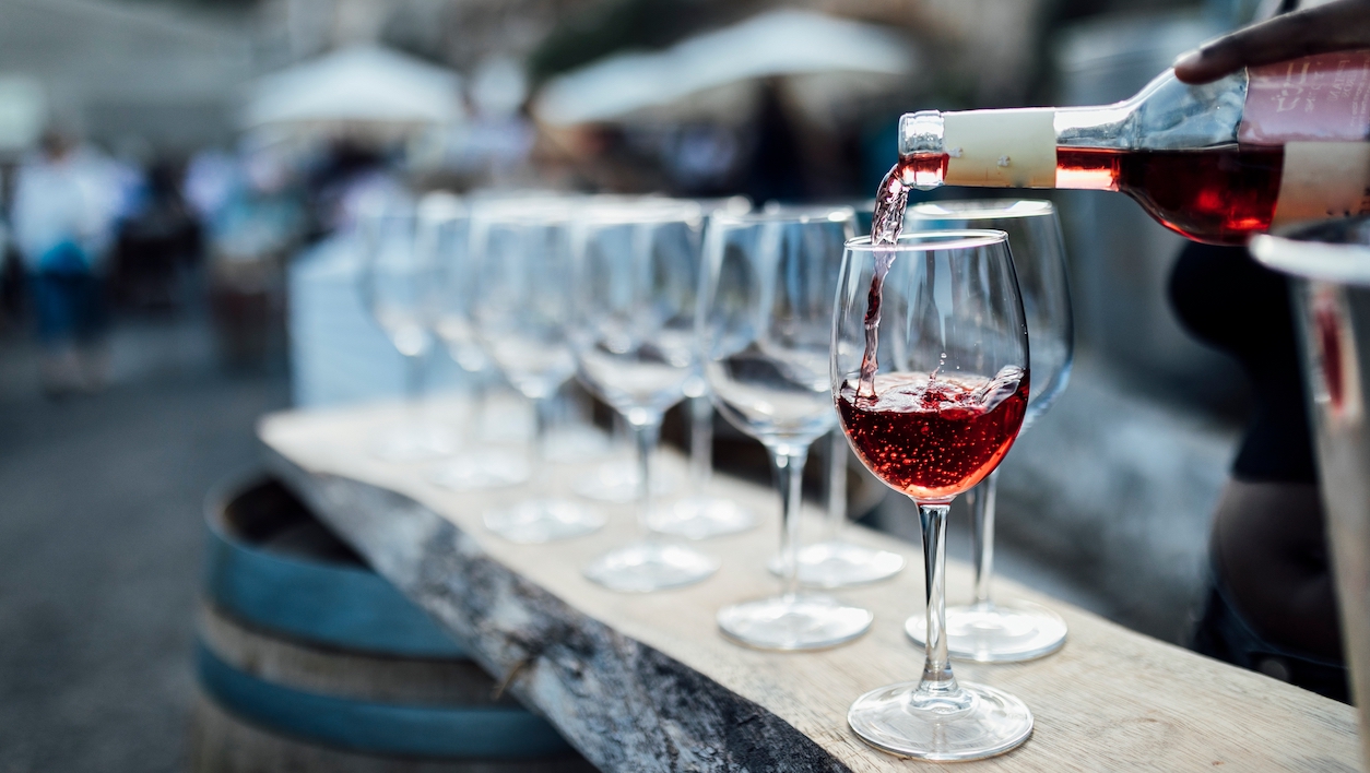 Get to know Rethymno wine festival in Crete pouring red wine in festival